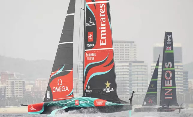 Ineos Britannia and Emirates Team New Zealand race during the Louis Vuitton 37th America's Cup Day 3 race 4 in Barcelona, Spain, Monday, Oct. 14, 2024. (AP Photo/Bernat Armangue)