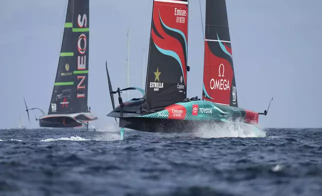 Ineos Britannia and Emirates Team New Zealand race during the Louis Vuitton 37th America's Cup Day 2 race in Barcelona, Spain, Sunday, Oct. 13, 2024. (AP Photo/Bernat Armangue)