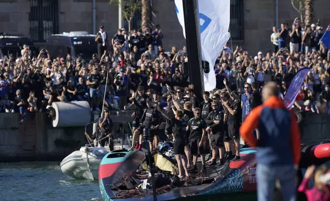 Emirates Team New Zealand crew celebrates after winning the Louis Vuitton 37th America's Cup in Barcelona, Spain, Saturday, Oct.19, 2024. (AP Photo/Bernat Armangue)