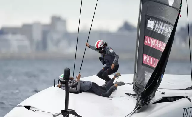 Luna Rossa Prada Pirelli's team celebrates after winning the Puig Women's America's Cup race in Barcelona, Spain, Saturday, Oct. 12, 2024. (AP Photo/Bernat Armangue)