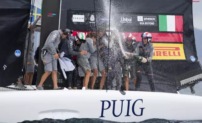 Luna Rossa Prada Pirelli's team celebrates after winning the Puig Women's America's Cup race in Barcelona, Spain, Saturday, Oct. 12, 2024. (AP Photo/Bernat Armangue)