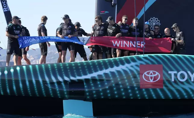 Emirates Team New Zealand crew celebrates after winning the Louis Vuitton 37th America's Cup in Barcelona, Spain, Saturday, Oct.19, 2024. (AP Photo/Bernat Armangue)