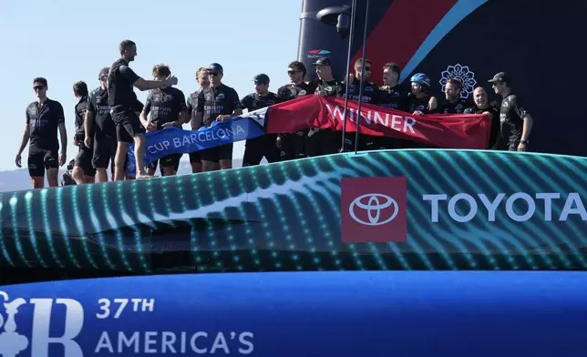 Emirates Team New Zealand crew celebrates after winning the Louis Vuitton 37th America's Cup in Barcelona, Spain, Saturday, Oct.19, 2024. (AP Photo/Bernat Armangue)