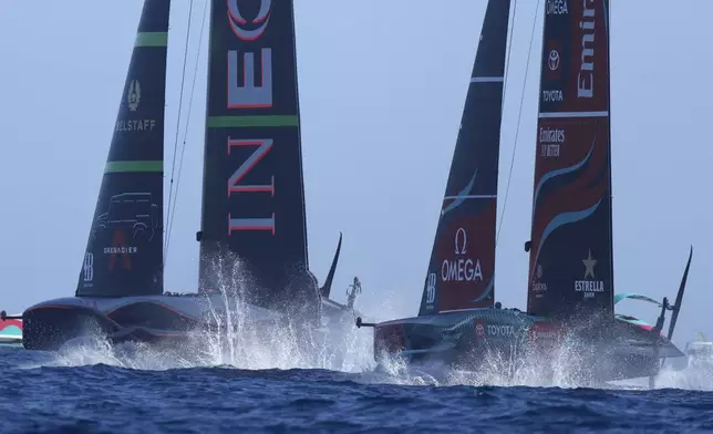 Emirates Team New Zealand, right, and Ineos Britannia race during the Louis Vuitton 37th America's Cup Day 4 race 6 in Barcelona, Spain, Wednesday, Oct. 16, 2024. (AP Photo/Bernat Armangue)