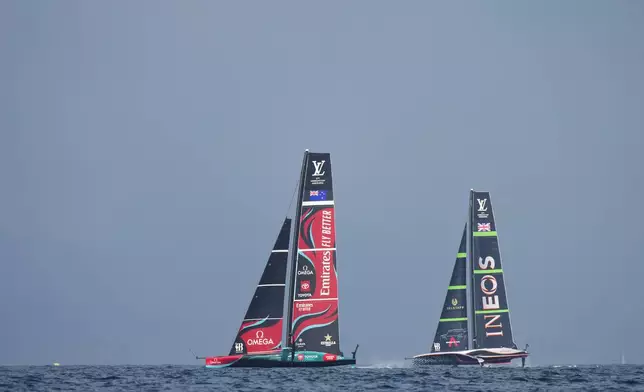 Ineos Britannia and Emirates Team New Zealand race during the Louis Vuitton 37th America's Cup race in Barcelona, Spain, Saturday, Oct. 12, 2024. (AP Photo/Bernat Armangue)