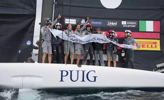 Luna Rossa Prada Pirelli's team celebrates after winning the Puig Women's America's Cup race in Barcelona, Spain, Saturday, Oct. 12, 2024. (AP Photo/Bernat Armangue)