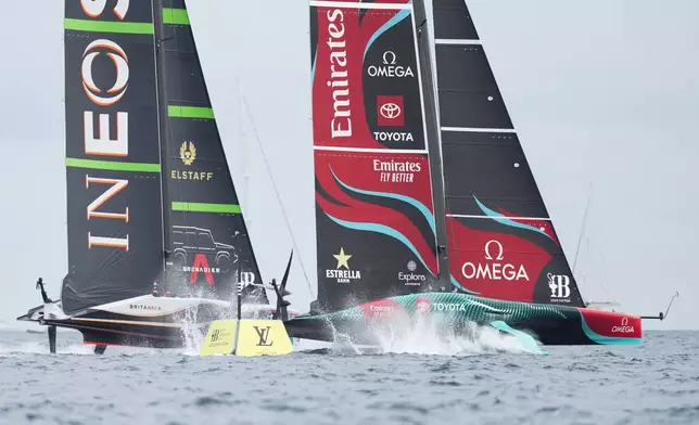 Ineos Britannia and Emirates Team New Zealand race during the Louis Vuitton 37th America's Cup race in Barcelona, Spain, Saturday, Oct. 12, 2024. (AP Photo/Bernat Armangue)