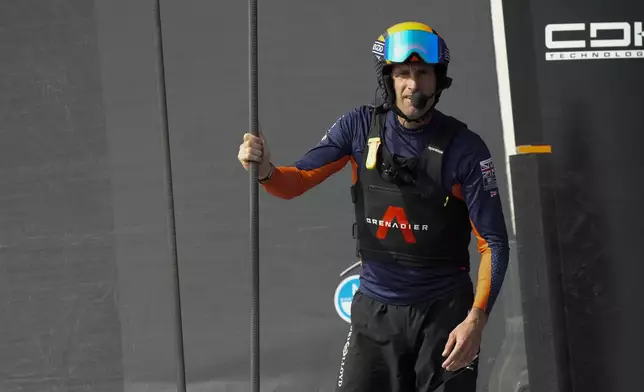 Ineos Britannia skipper Ben Ainslie, center santds before the Louis Vuitton 37th America's Cup Day 2 race in Barcelona, Spain, Sunday, Oct. 13, 2024. (AP Photo/Bernat Armangue)