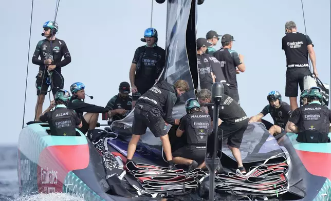 Emirates Team New Zealand crew prepares for the race during the Louis Vuitton 37th America's Cup Day 2 race in Barcelona, Spain, Sunday, Oct. 13, 2024. (AP Photo/Bernat Armangue)