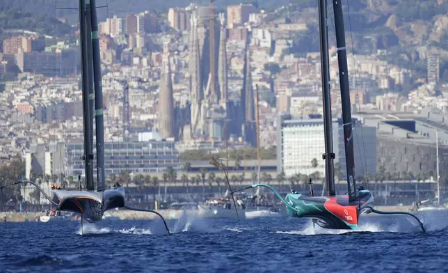 Emirates Team New Zealand, right, and Ineos Brittania race during the Louis Vuitton 37th America's Cup Day 6 race 9 in Barcelona, Spain, Saturday, Oct.19, 2024. (AP Photo/Bernat Armangue)