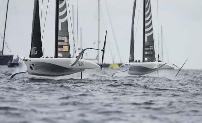 Luna Rossa Prada Pirelli and Athena Pathway teams race during team races during the Puig Womne's America's Cup race in Barcelona, Spain, Saturday, Oct. 12, 2024. (AP Photo/Bernat Armangue)