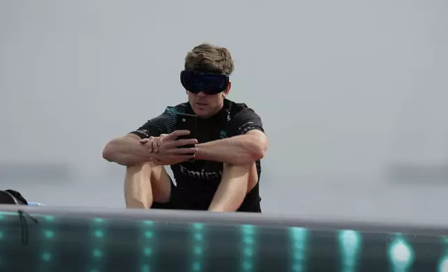 Emirates Team New Zealand skipper Peter Burling checks a screen before the Louis Vuitton 37th America's Cup race in Barcelona, Spain, Saturday, Oct. 12, 2024. (AP Photo/Bernat Armangue)