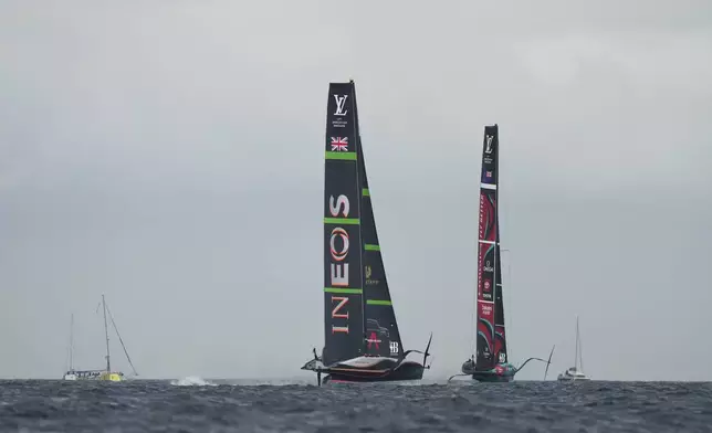 Ineos Britannia and Emirates Team New Zealand race during the Louis Vuitton 37th America's Cup race in Barcelona, Spain, Saturday, Oct. 12, 2024. (AP Photo/Bernat Armangue)