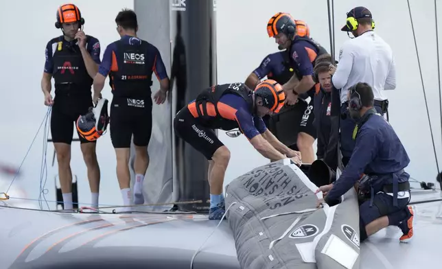 Ineos Britannia crew prepares for the Louis Vuitton 37th America's Cup Day 5 race 7 in Barcelona, Spain, Friday, Oct. 18, 2024. (AP Photo/Bernat Armangue)