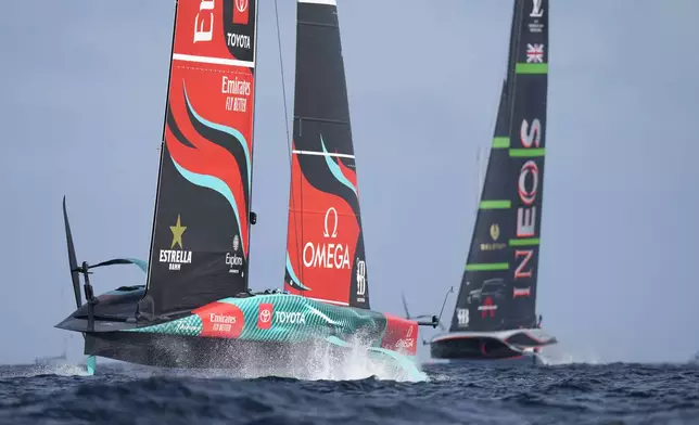 Ineos Britannia and Emirates Team New Zealand race during the Louis Vuitton 37th America's Cup Day 2 race in Barcelona, Spain, Sunday, Oct. 13, 2024. (AP Photo/Bernat Armangue)