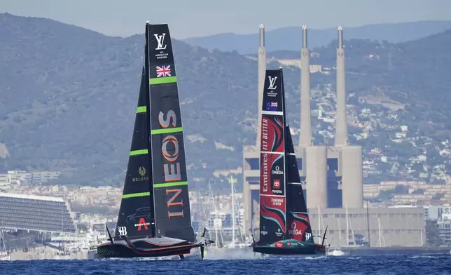 Emirates Team New Zealand and Ineos Brittania race during the Louis Vuitton 37th America's Cup Day 6 race 9 in Barcelona, Spain, Saturday, Oct.19, 2024. (AP Photo/Bernat Armangue)