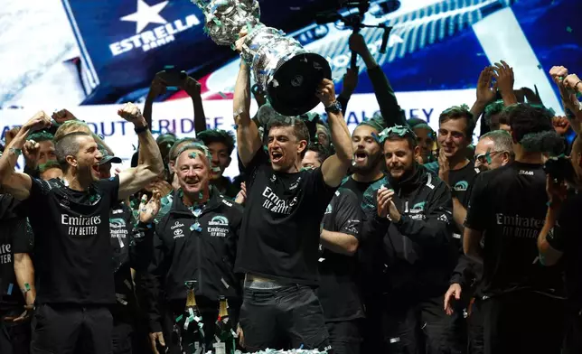 Emirates Team New Zealand crew celebrates after winning the Louis Vuitton 37th America's Cup in Barcelona, Spain, Saturday, Oct.19, 2024. (AP Photo/Joan Monfort)