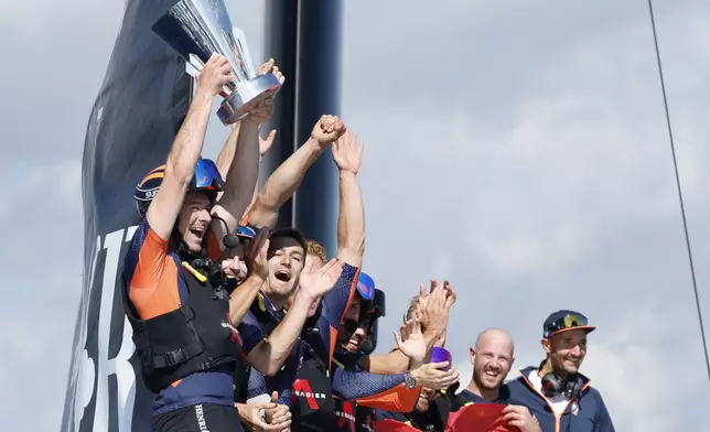 INEOS Britannia crew celebrate their victory against the Luna Rosa Prada Pirelli's sailing team during the Louis Vuitton Cup Final Day 7 at the Barcelona's coast, Spain, Friday, Oct. 4, 2024. (AP Photo/Joan Monfort)