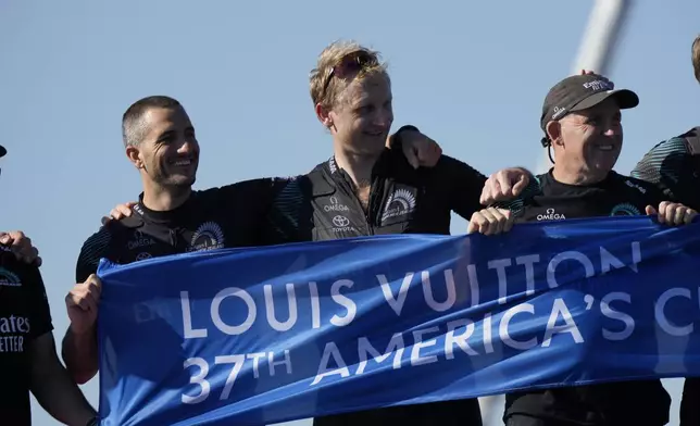 Emirates Team New Zealand crew celebrates after winning the Louis Vuitton 37th America's Cup in Barcelona, Spain, Saturday, Oct.19, 2024. (AP Photo/Bernat Armangue)