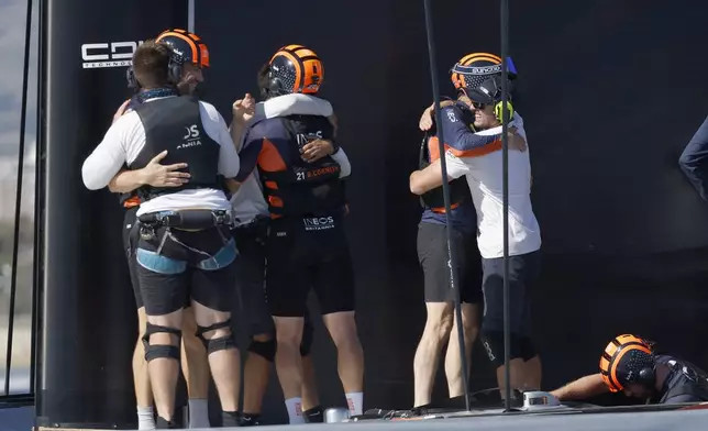 INEOS Britannia crew celebrate their victory against the Luna Rosa Prada Pirelli's sailing team during the Louis Vuitton Cup Final Day 7 at the Barcelona's coast, Spain, Friday, Oct. 4, 2024. (AP Photo/Joan Monfort)