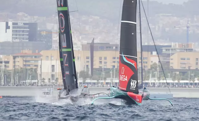 Ineos Britannia and Emirates Team New Zealand race during the Louis Vuitton 37th America's Cup Day 2 race in Barcelona, Spain, Sunday, Oct. 13, 2024. (AP Photo/Bernat Armangue)