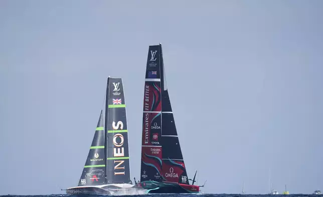 Ineos Britannia and Emirates Team New Zealand race during the Louis Vuitton 37th America's Cup Day 2 race in Barcelona, Spain, Sunday, Oct. 13, 2024. (AP Photo/Bernat Armangue)