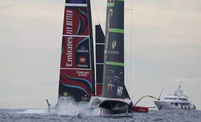 Ineos Britannia and Emirates Team New Zealand race during Louis Vuitton 37th America's Cup Day 5 race 7 in Barcelona, Spain, Friday, Oct. 18, 2024. (AP Photo/Bernat Armangue)