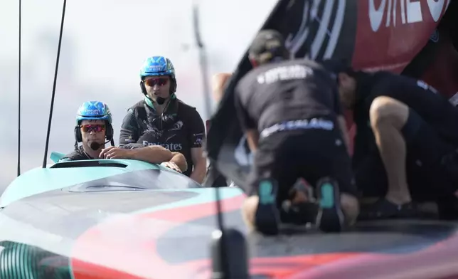 Emirates Team New Zealand crew prepares for the Louis Vuitton 37th America's Cup Day 2 race in Barcelona, Spain, Sunday, Oct. 13, 2024. (AP Photo/Bernat Armangue)