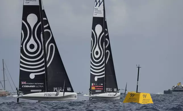 Luna Rossa Prada Pirelli and Athena Pathway teams race during team races during the Puig Womne's America's Cup race in Barcelona, Spain, Saturday, Oct. 12, 2024. (AP Photo/Bernat Armangue)