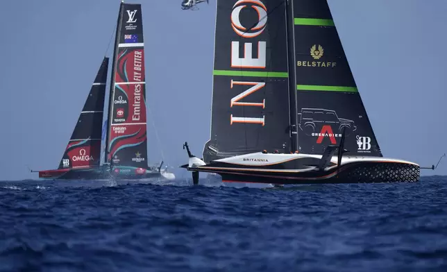 Ineos Britannia, right, and Emirates Team New Zealand race during the Louis Vuitton 37th America's Cup Day 4 race 5 in Barcelona, Spain, Wednesday, Oct. 16, 2024. (AP Photo/Bernat Armangue)