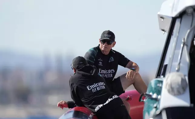 Emirates Team New Zealand CEO Grant Dalton talks to a crew member crew ahead of the Louis Vuitton 37th America's Cup Day 6 race 9 in Barcelona, Spain, Saturday, Oct.19, 2024. (AP Photo/Bernat Armangue)