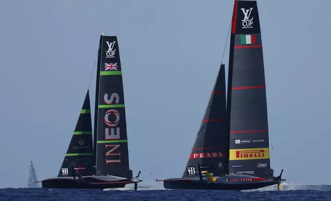 INEOS Britannia, left, and Luna Rosa Prada Pirelli sailing teams compete during the Louis Vuitton Cup Final Day 7 at the Barcelona's coast, Spain, Friday, Oct. 4, 2024. (AP Photo/Joan Monfort)