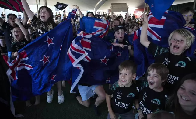 Emirates Team New Zealand fans celebrate as their team won the Louis Vuitton 37th America's Cup in Barcelona, Spain, Saturday, Oct. 19, 2024. (AP Photo/Emilio Morenatti)