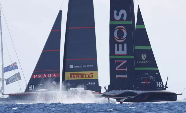 INEOS Britannia, right, and Luna Rosa Prada Pirelli sailing teams compete during the Louis Vuitton Cup Final Day 7 at the Barcelona's coast, Spain, Friday, Oct. 4, 2024. (AP Photo/Joan Monfort)