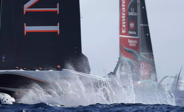 Ineos Britannia, left, and Emirates Team New Zealand race during the Louis Vuitton 37th America's Cup Day 4 race 5 in Barcelona, Spain, Wednesday, Oct. 16, 2024. (AP Photo/Bernat Armangue)