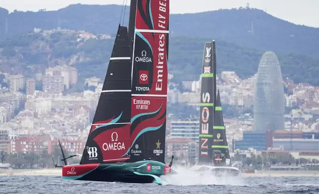 Ineos Britannia and Emirates Team New Zealand race during Louis Vuitton 37th America's Cup Day 5 race 8 in Barcelona, Spain, Friday, Oct. 18, 2024. (AP Photo/Bernat Armangue)