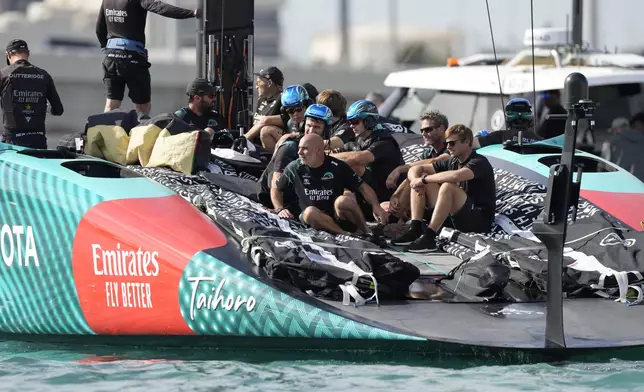 Emirates Team New Zealand crew waits for the Louis Vuitton 37th America's Cup Day 6 race 9 in Barcelona, Spain, Saturday, Oct.19, 2024. (AP Photo/Bernat Armangue)