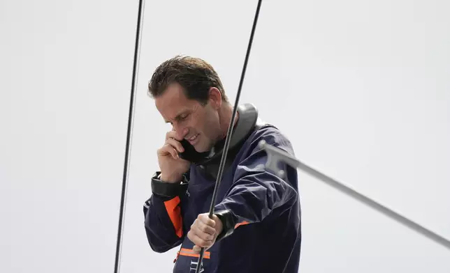 Ineos Britannia skipper Ben Ainslie talks on the phone before the Louis Vuitton 37th America's Cup race in Barcelona, Spain, Saturday, Oct. 12, 2024. (AP Photo/Bernat Armangue)