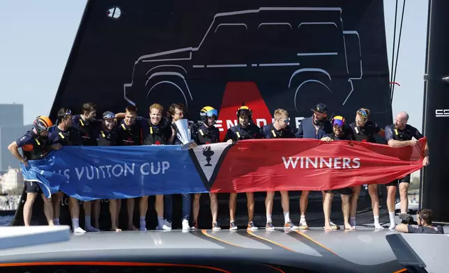 INEOS Britannia crew celebrate their victory against the Luna Rosa Prada Pirelli's sailing team during the Louis Vuitton Cup Final Day 7 at the Barcelona's coast, Spain, Friday, Oct. 4, 2024. (AP Photo/Joan Monfort)