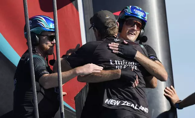 Emirates Team New Zealand crew celebrates after winning the Louis Vuitton 37th America's Cup in Barcelona, Spain, Saturday, Oct.19, 2024. (AP Photo/Bernat Armangue)