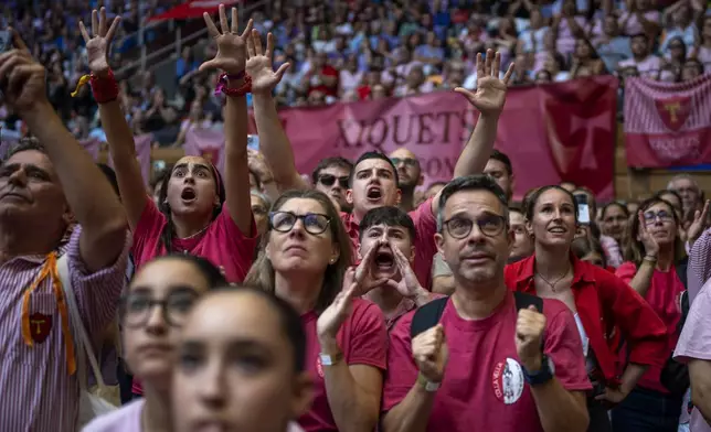 Members of "Colla Joves Xiquets de Valls" react as they form a "Castell" or human tower, during the 29th Human Tower Competition in Tarragona, Spain, Sunday, Oct. 6, 2024. (AP Photo/Emilio Morenatti)