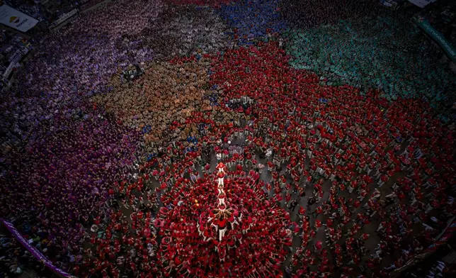 Members of "Colla Joves Xiquets de Valls" form a "Castell" or human tower, during the 29th Human Tower Competition in Tarragona, Spain, Sunday, Oct. 6, 2024. (AP Photo/Emilio Morenatti)