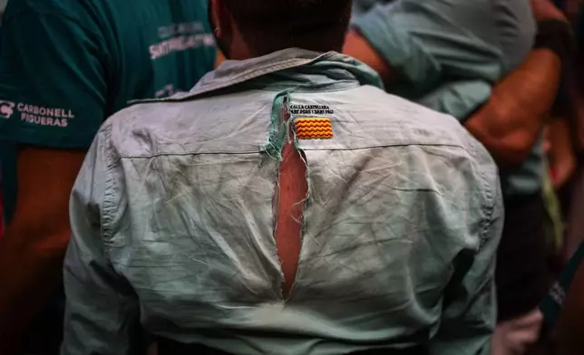 The torn shirt of an assistant is photographed after completing a "Castellers" or human tower during the 29th Human Tower Competition in Tarragona, Spain, Saturday, Oct. 5, 2024. (AP Photo/Emilio Morenatti)