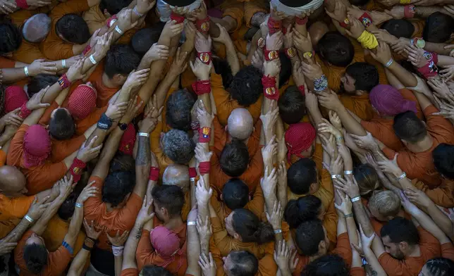 Members of "Sagals d'Osona" form a "Castell" or human tower, during the 29th Human Tower Competition in Tarragona, Spain, Saturday, Oct. 5, 2024. (AP Photo/Emilio Morenatti)