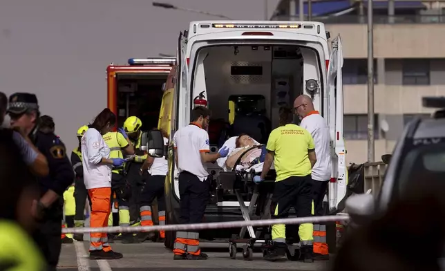 A woman is taken away in an ambulance after being rescued from the floods in Valencia, Spain, Wednesday, Oct. 30, 2024. (AP Photo/Alberto Saiz)