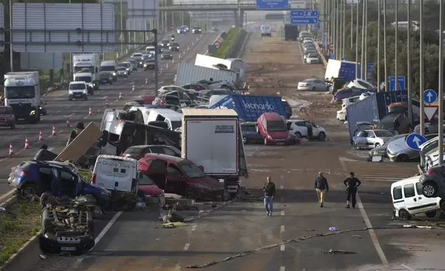 Vehicles are seen piled up after being swept away by floods on a motorway in Valencia, Spain, Thursday, Oct. 31, 2024. (AP Photo/Manu Fernandez)