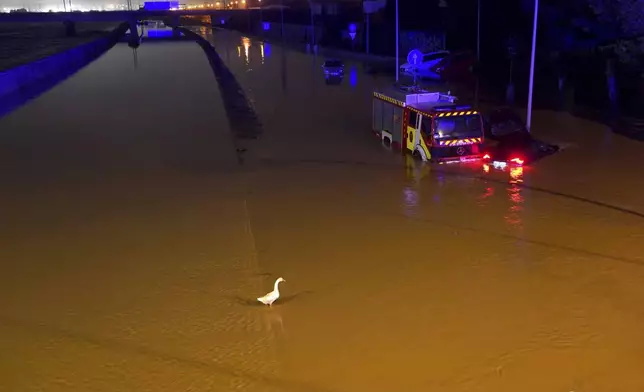 Cars are trapped by flooding in Valencia, Wednesday, Oct. 30, 2024. (AP Photo/Alberto Saiz)