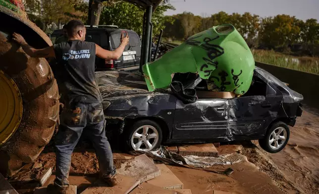 Flooded cars are piled up in Utiel, Spain, Wednesday, Oct. 30, 2024. (AP Photo/Manu Fernandez)