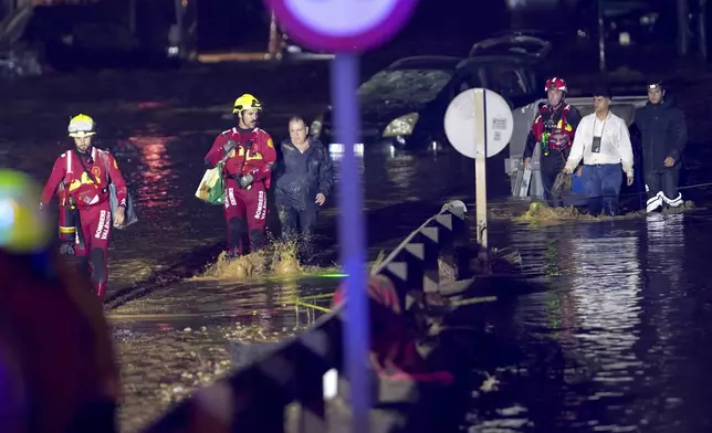 Emergency crew rescue residents after they were trapped in their homes following flooding in Valencia, Wednesday, Oct. 30, 2024. (AP Photo/Alberto Saiz)