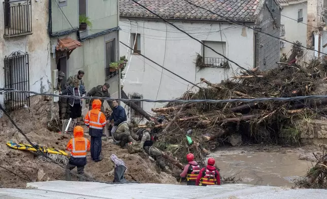 Members of the Spanish army and emergency services rescue people trapped in their homes after floods in Letur, Albacete, Tuesday, Oct. 29, 2024. (Víctor Fernández/Europa Press via AP)